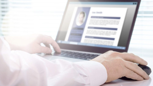 Man working on laptop to build his Master CV and update his professional achievements